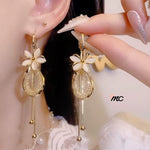 Pendientes con borlas de flores y piedra de ojo de gato