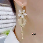 Pendientes con borlas de flores y piedra de ojo de gato